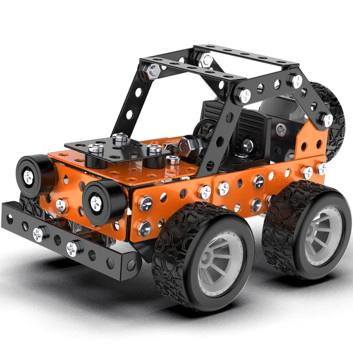 Close-up of an orange and black off-road metal model with silver wheels and bolted body panels
