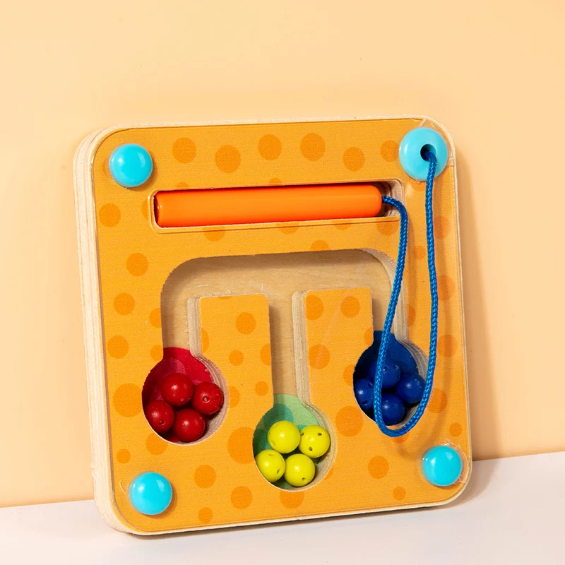 Orange bead maze board with colored balls, sorting channels, and a tethered orange pen.