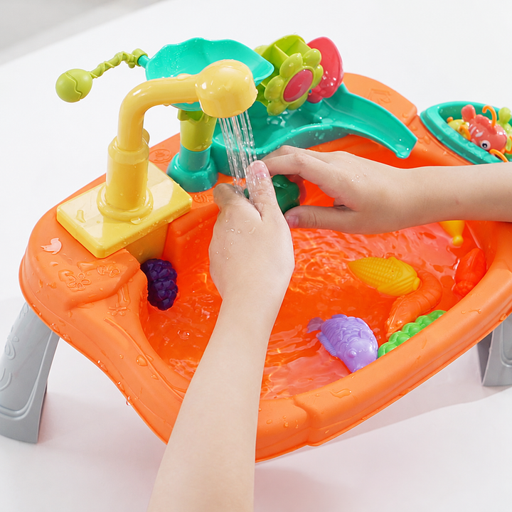 Hands held beneath the running faucet of the orange play sink