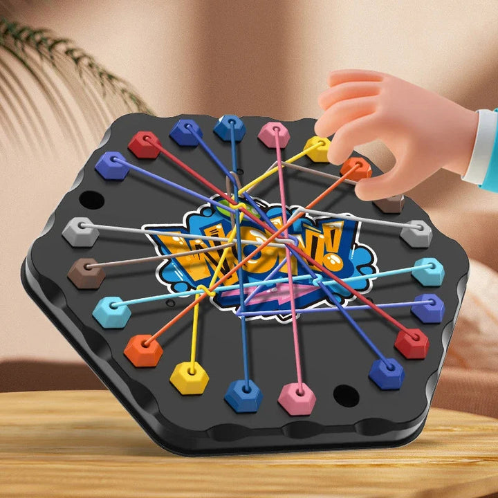 Hand lifting an orange rope connector on a black hexagonal puzzle board.