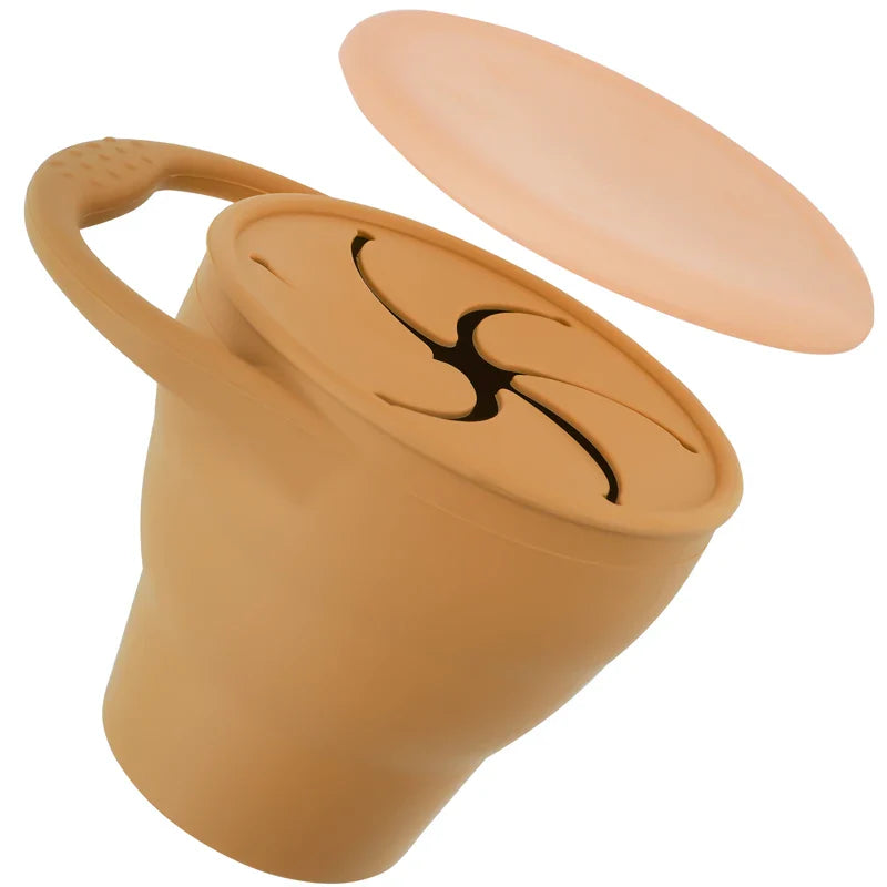 Orange silicone snack cup with its cover lifted above the petal-style opening