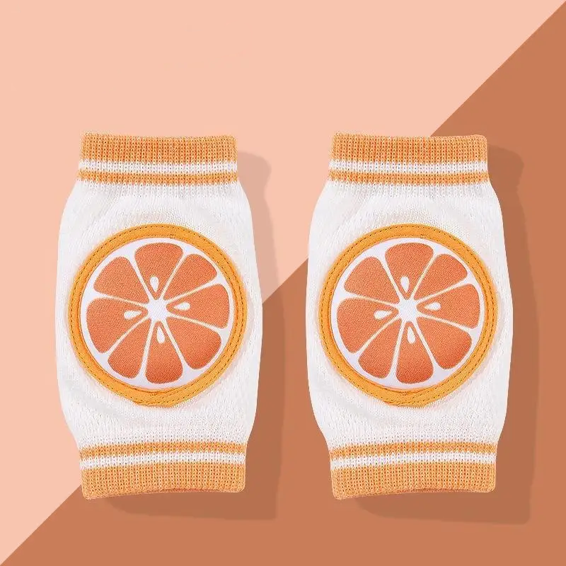 Pair of orange-slice knee pads with yellow trim and white knit sleeves.
