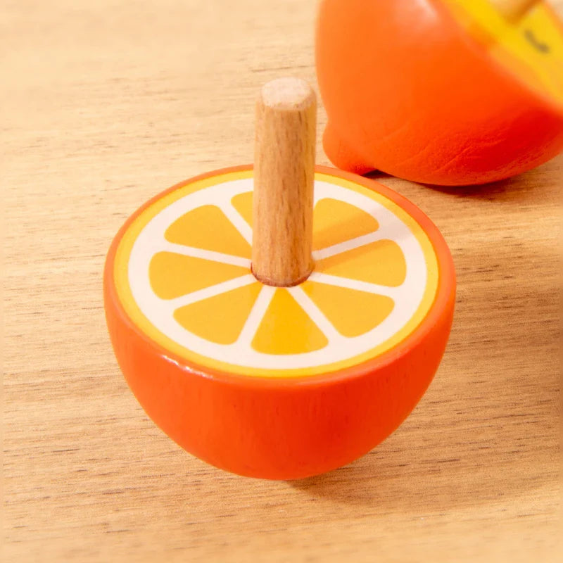 Orange-slice wooden spinning top with an upright natural wood stem
