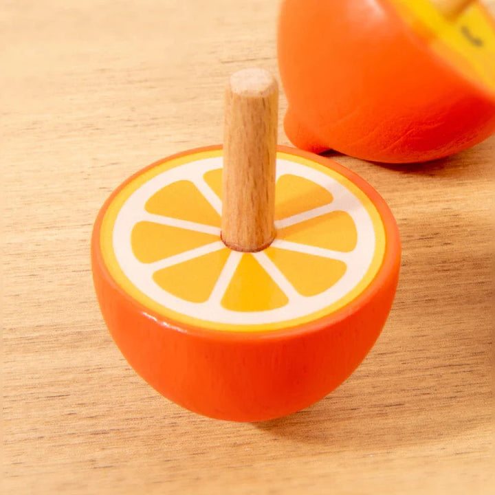Orange-slice wooden spinning top with an upright natural wood stem