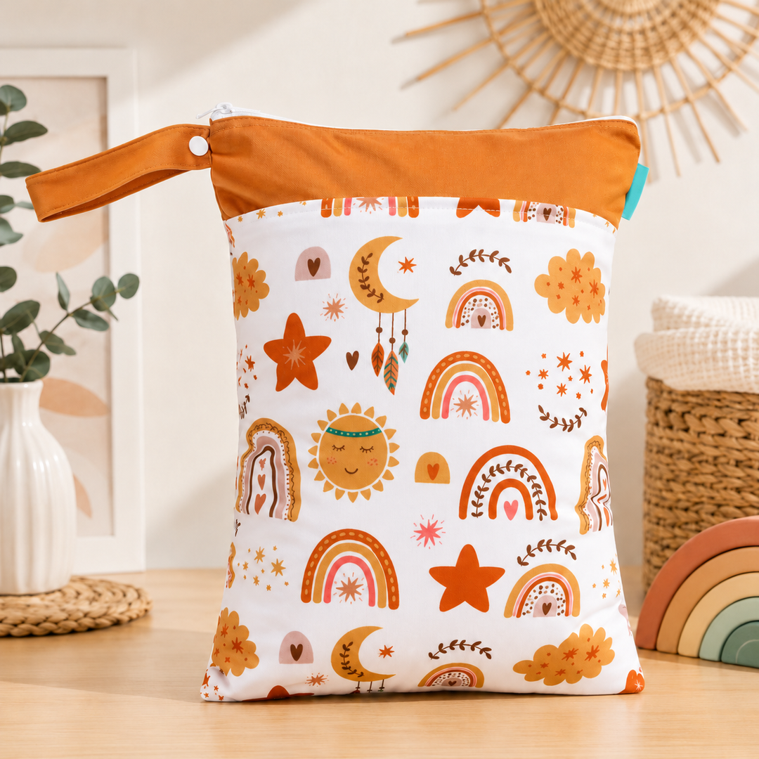 Orange-trim diaper wet bag with sun, rainbow, and flower prints