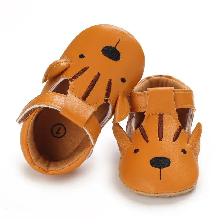 Orange tiger-face baby shoes with dark stripes and strap closures