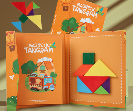 Open orange tangram booklet with vehicle artwork and magnetic shapes arranged as a house