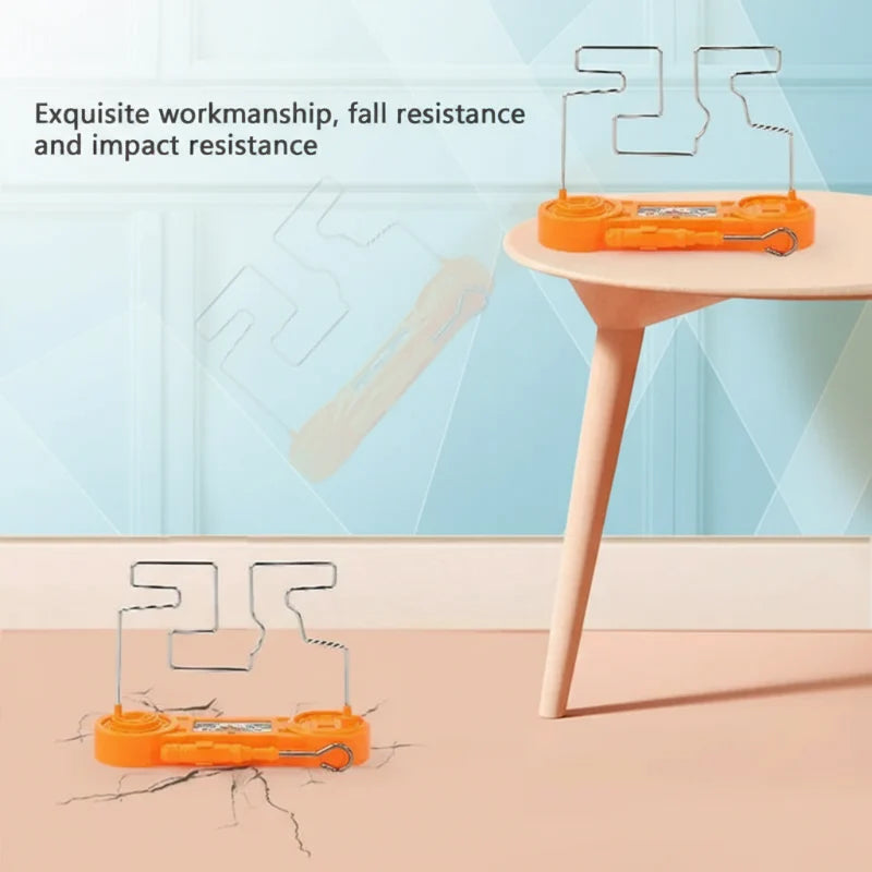Orange wire maze game shown on a table and on the floor