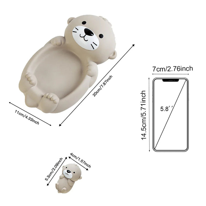 Otter bath toy dimensions shown beside a phone illustration for size comparison