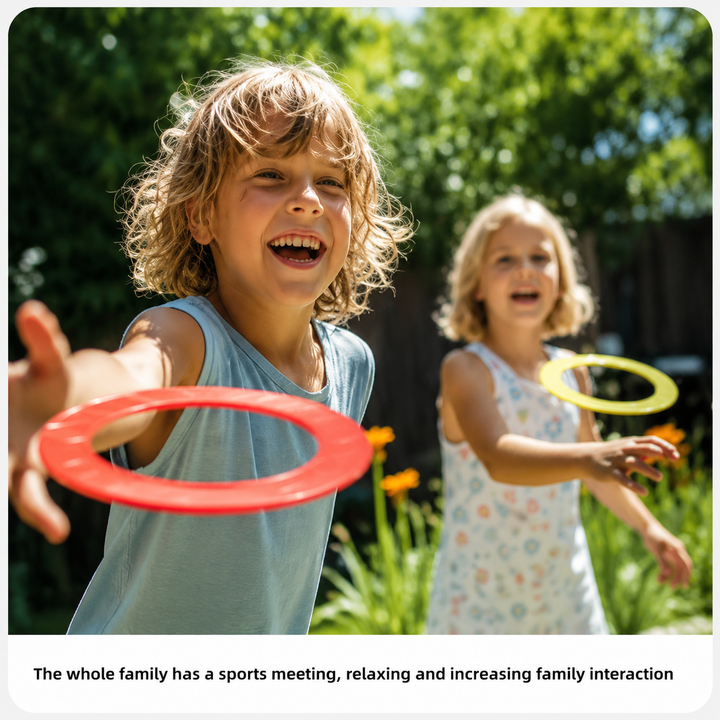 Two children tossing colorful rings outdoors