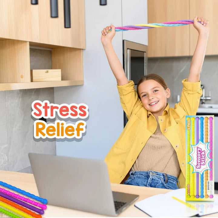 Person stretching multicolored fidget sticks overhead while seated at a laptop
