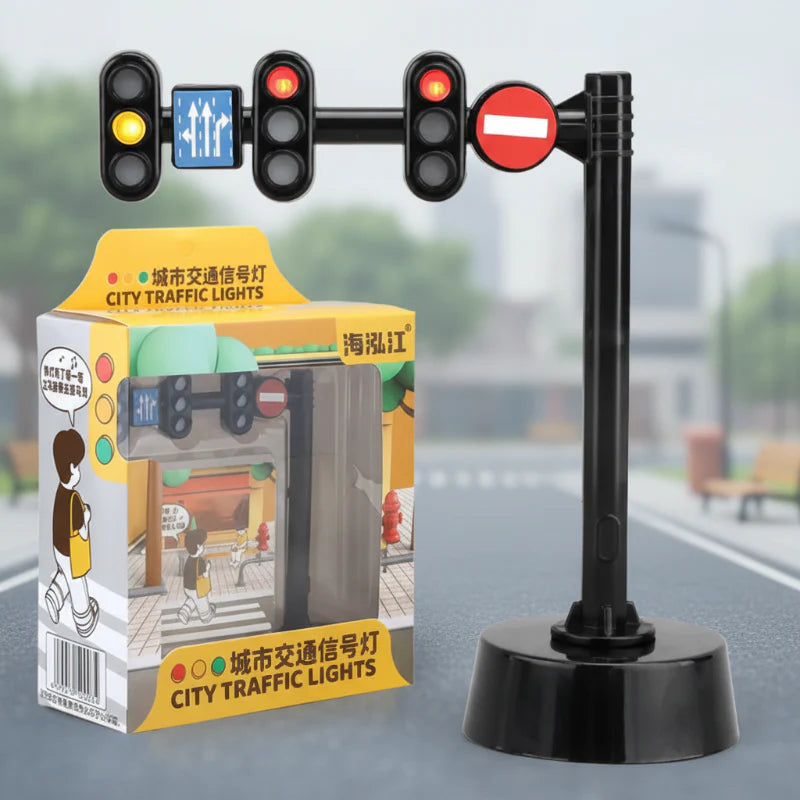 Overhead toy traffic light with three signal heads, road signs, a round base, and retail box.