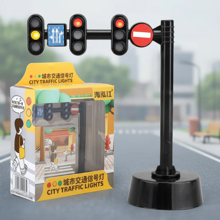 Overhead toy traffic light with three signal heads, road signs, a round base, and retail box.