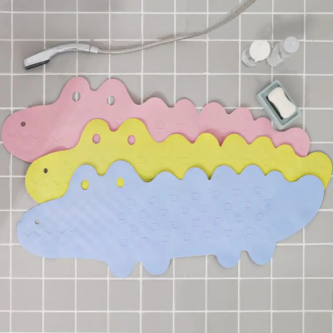 Three overlapping crocodile bath mats arranged on gray bathroom tiles