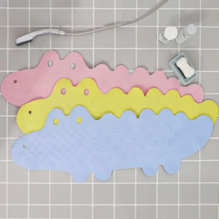 Three overlapping crocodile bath mats arranged on gray bathroom tiles