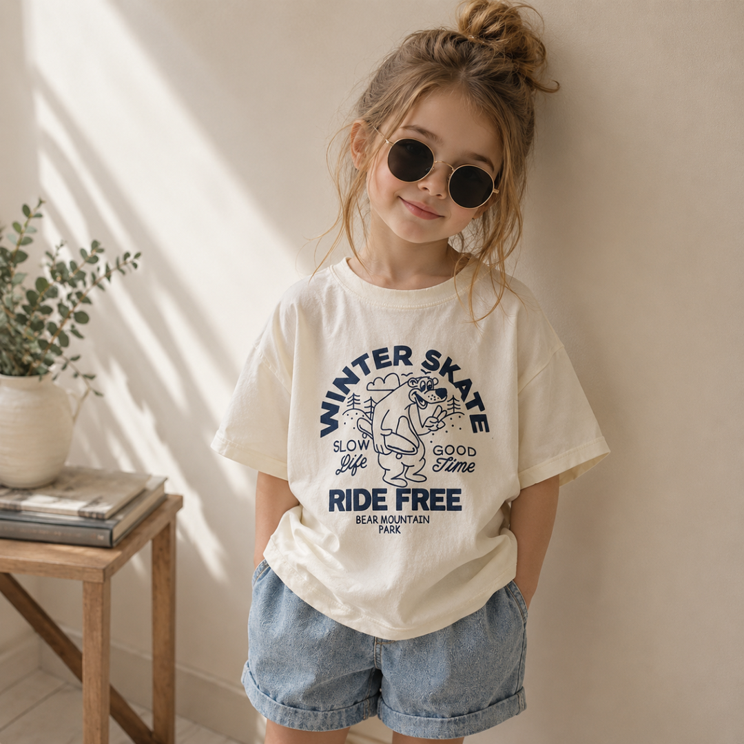 Girl wearing an oversized skate bear T-shirt with denim shorts and round sunglasses