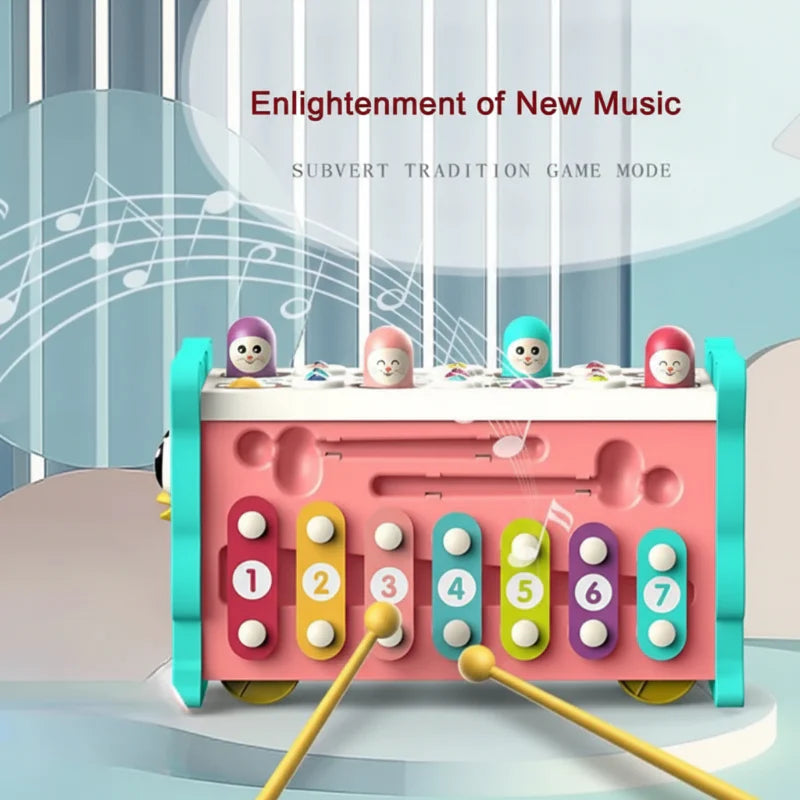 Seven colorful numbered xylophone keys with two mallets on the owl activity center