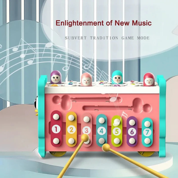Seven colorful numbered xylophone keys with two mallets on the owl activity center