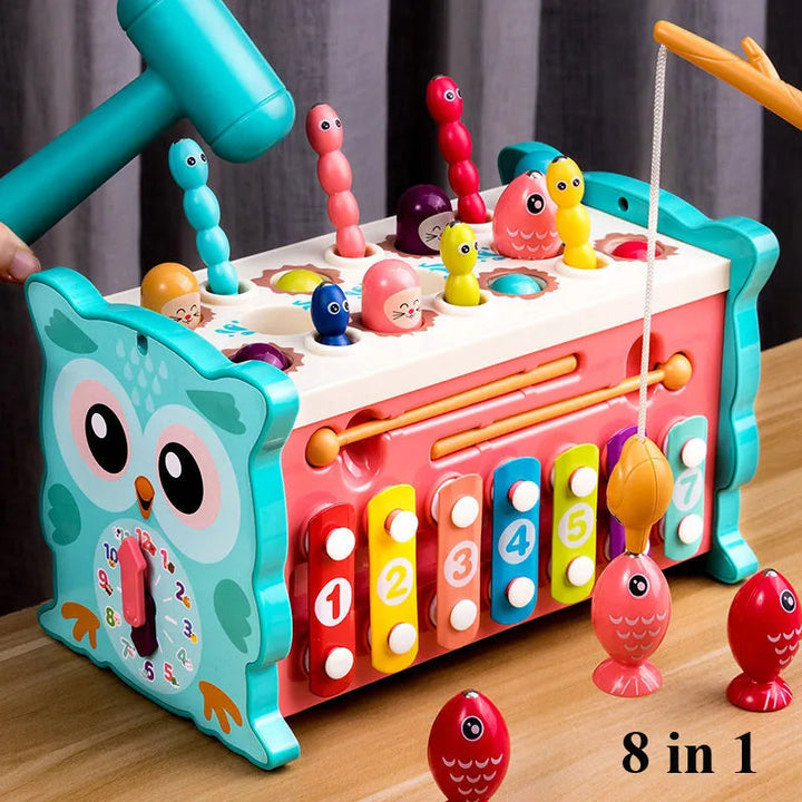 Owl activity center with a numbered xylophone, side clock, hammer, and magnetic fish