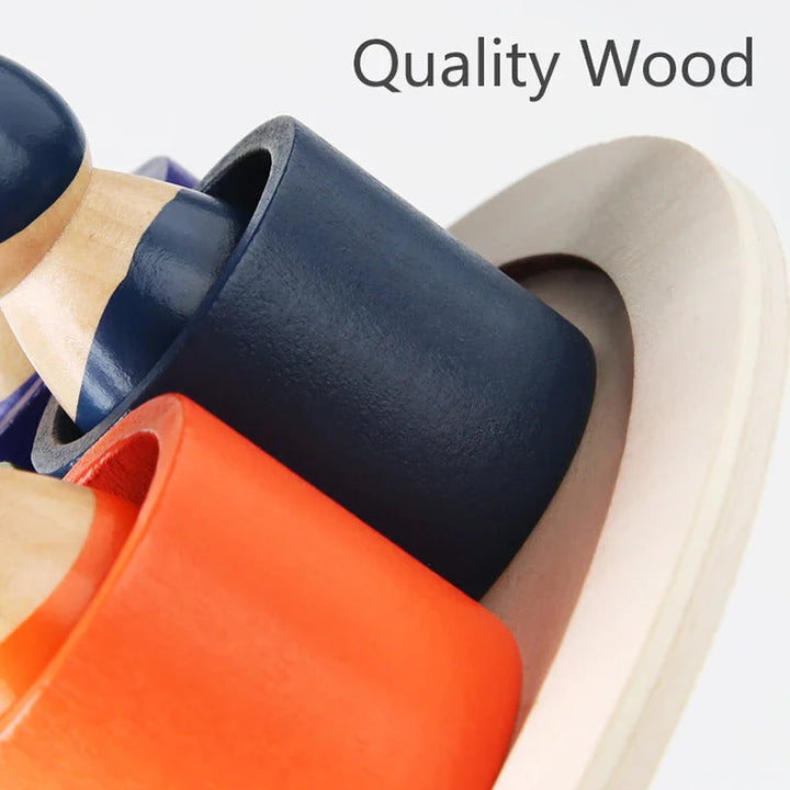Close-up of orange and dark blue wooden bowls with a figure on the round board