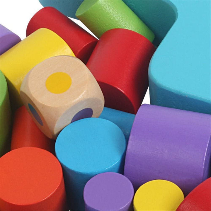 Close-up of painted wooden cylinders and a wooden die with colored dots