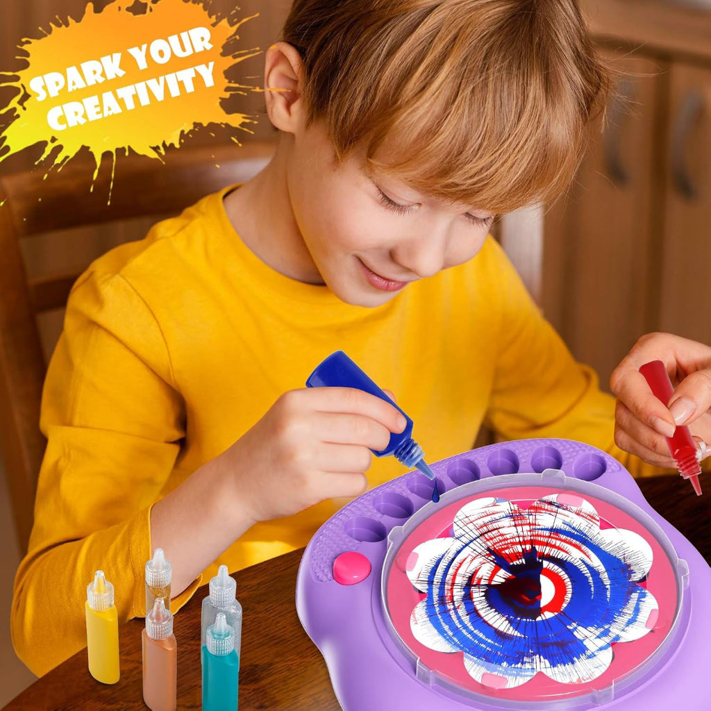 Child adding blue paint to a red, white, and blue design on the purple spin painter