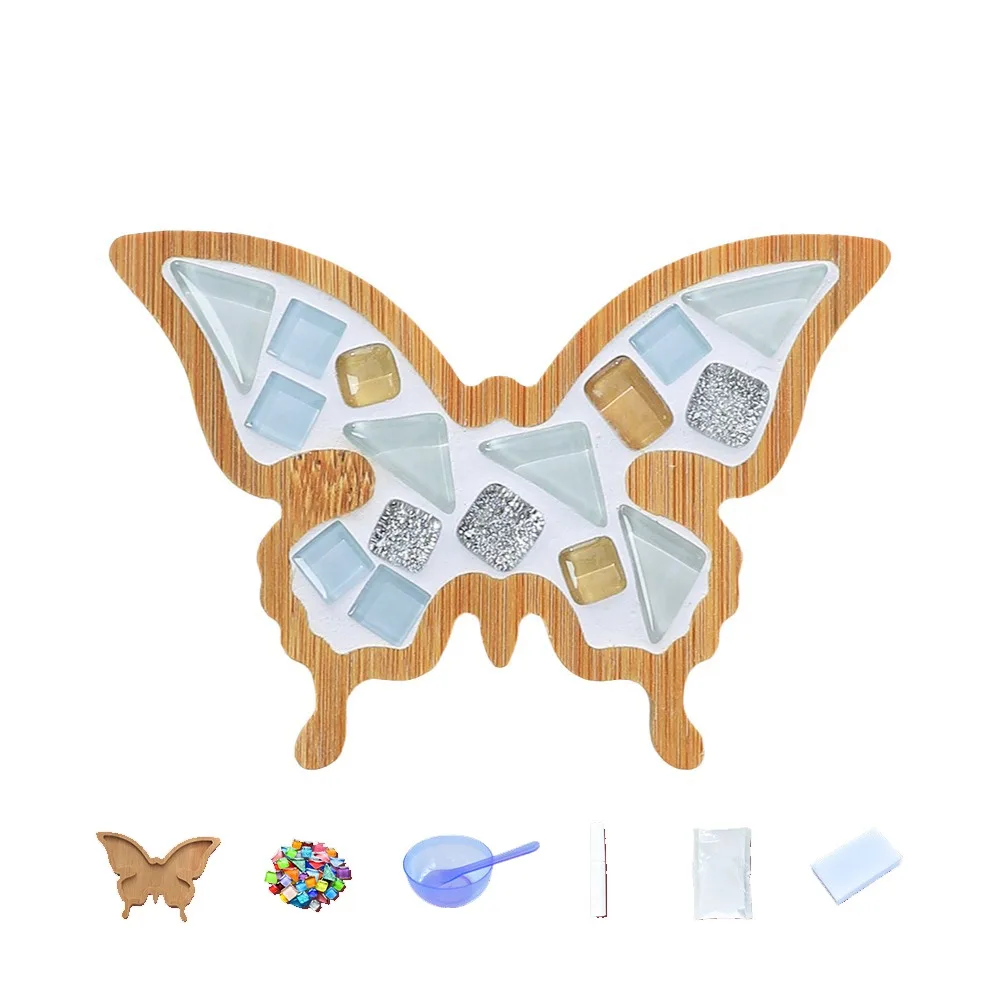 Pale blue, white and metallic-look butterfly mosaic coaster shown with crafting supplies