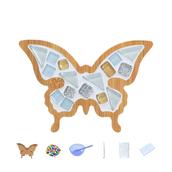 Pale blue, white and metallic-look butterfly mosaic coaster shown with crafting supplies