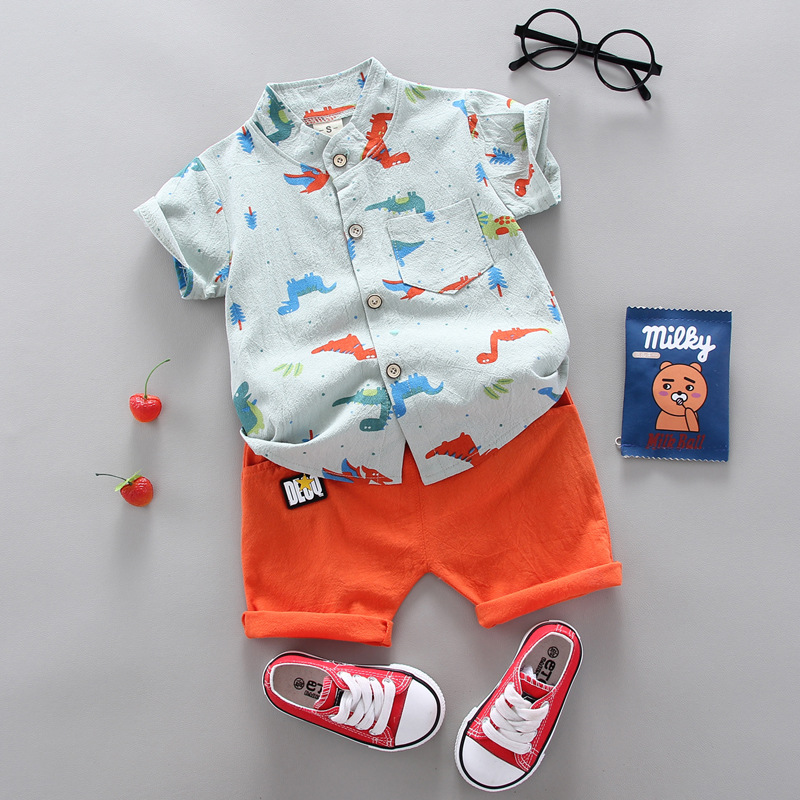 Pale blue dinosaur-print shirt paired with orange shorts