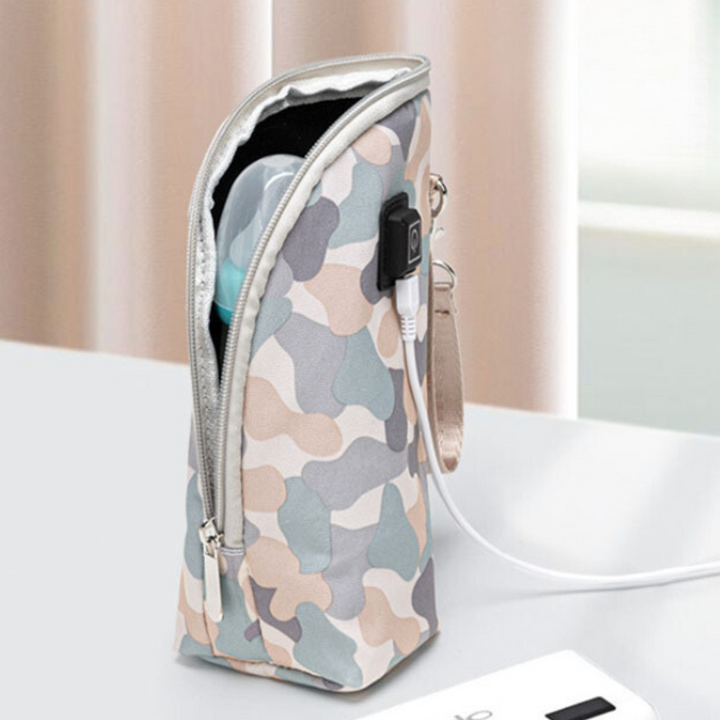 Pale camouflage zippered bottle warmer with wrist strap and USB cable attached.