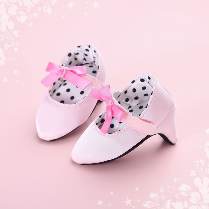 Pale pink baby shoes with small pink bows and polka-dot lining