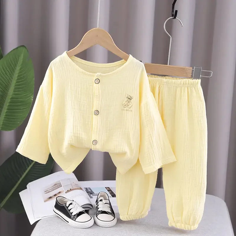 Pale yellow pajama set with a button-front top and matching gathered-cuff pants