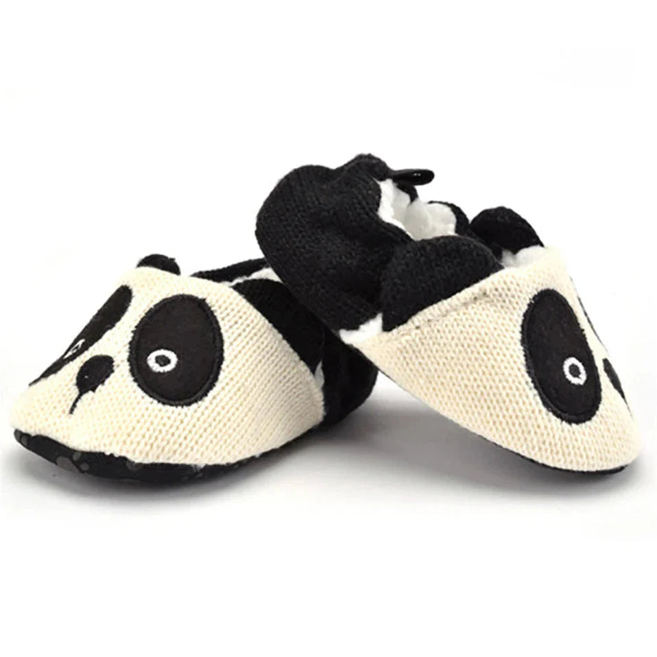 Pair of black-and-white panda baby slippers shown at an angle