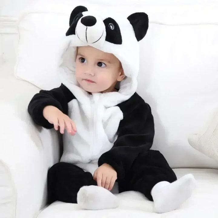 Baby wearing a black-and-white panda onesie with rounded ears on the hood