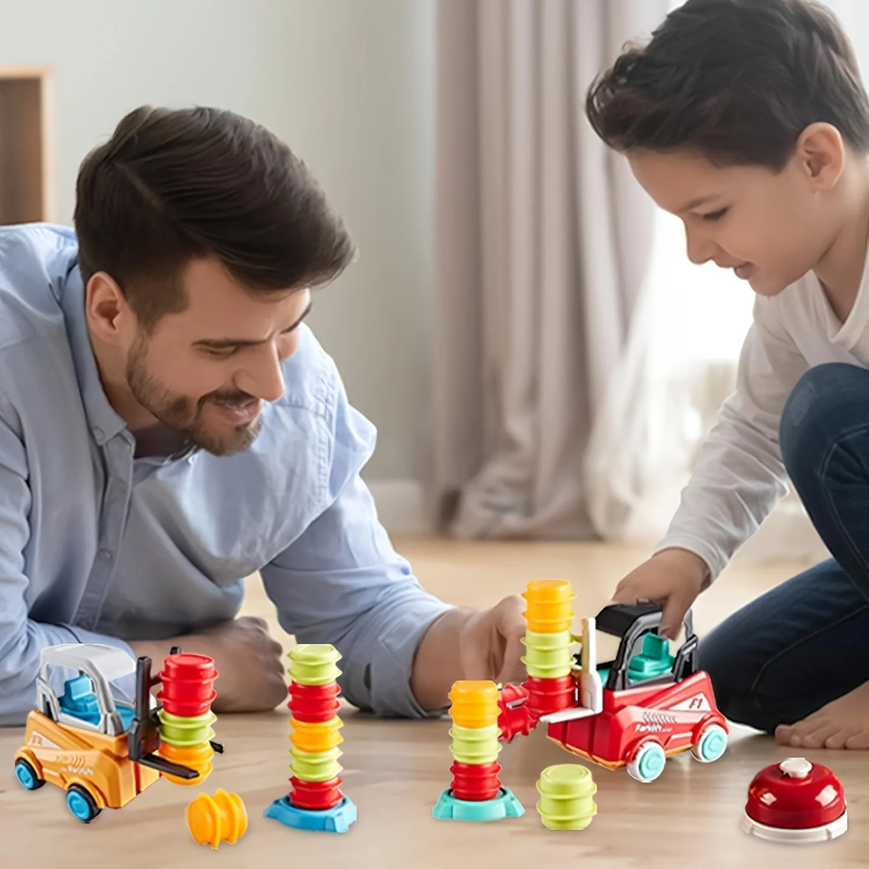 An adult and child playing with forklifts, stacking pieces, and a bell on the floor