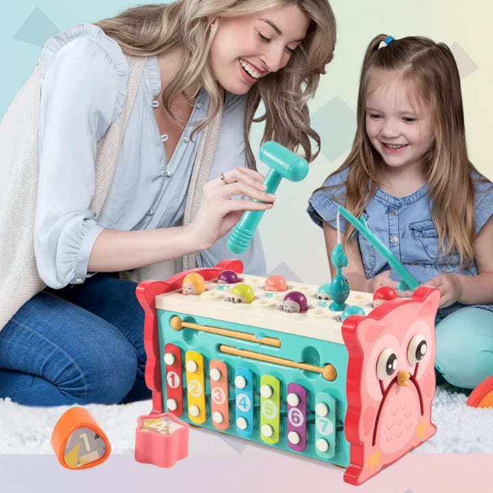 Adult and child exploring the owl hammering toy with a hammer and magnetic fishing rod