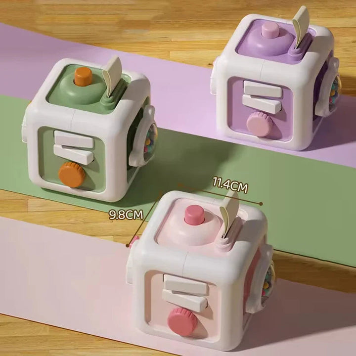 Green, purple, and pink activity cubes with 9.8 cm and 11.4 cm measurement labels