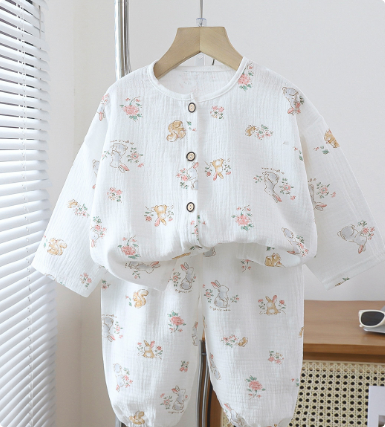 White pajama set with small pastel animal illustrations and a button-front top