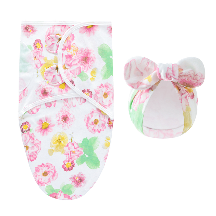 Swaddle blanket and matching bow hat with pastel pink flowers and green leaves