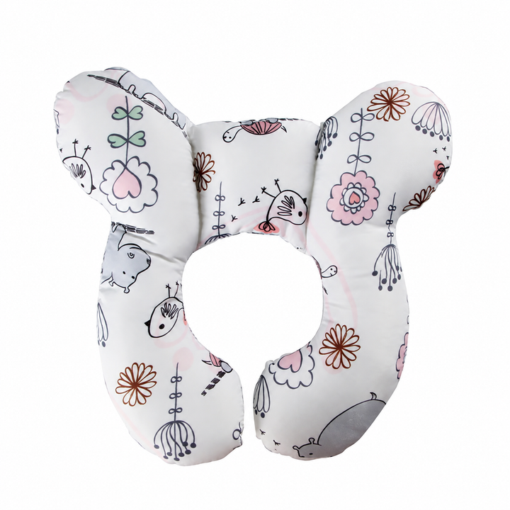 White contoured pillow with pastel pink, gray, and green illustrated motifs