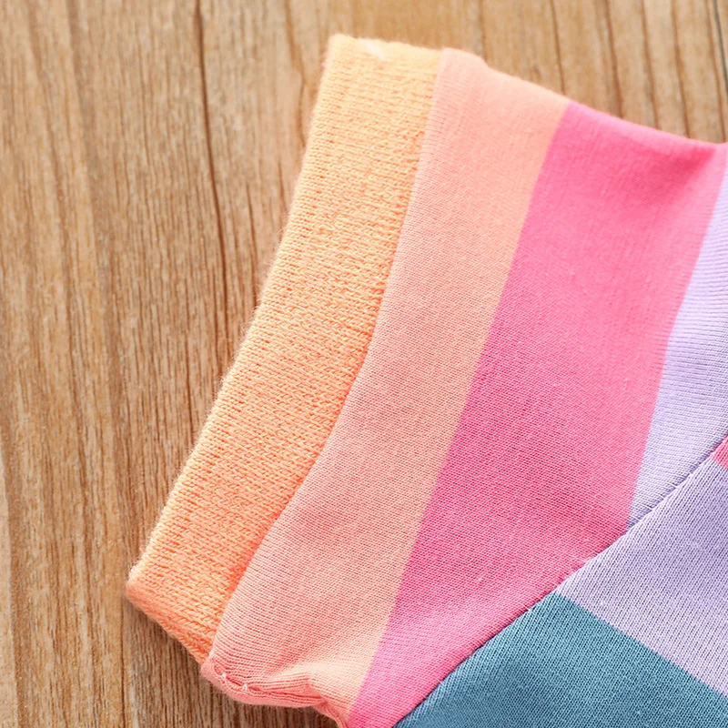 Short sleeve with peach trim on the pastel rainbow-striped polo dress