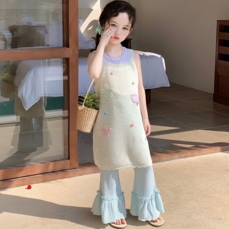 Girl wearing the pastel summer separates with a small woven bag on a patio