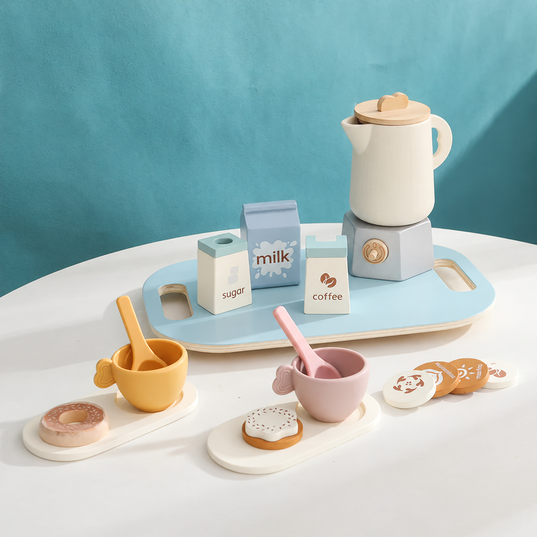 Toy tea set with a cream teapot, pastel cups, play food, and a blue serving tray