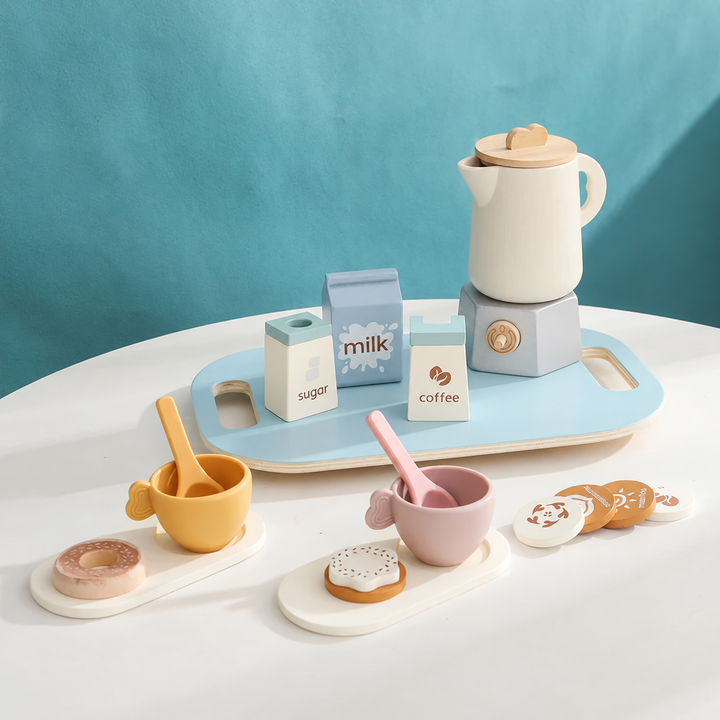 Toy tea set with a cream teapot, pastel cups, play food, and a blue serving tray