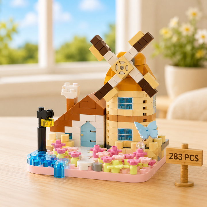 Pastel yellow windmill building-block model with flowers, a blue stream and a 283-piece sign.
