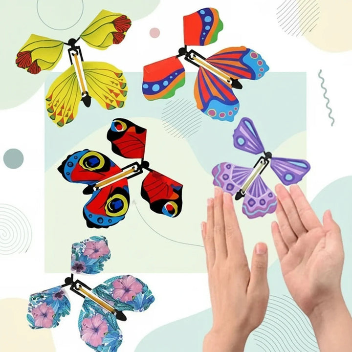 Colorful butterfly toys with floral and geometric wing patterns shown above open hands