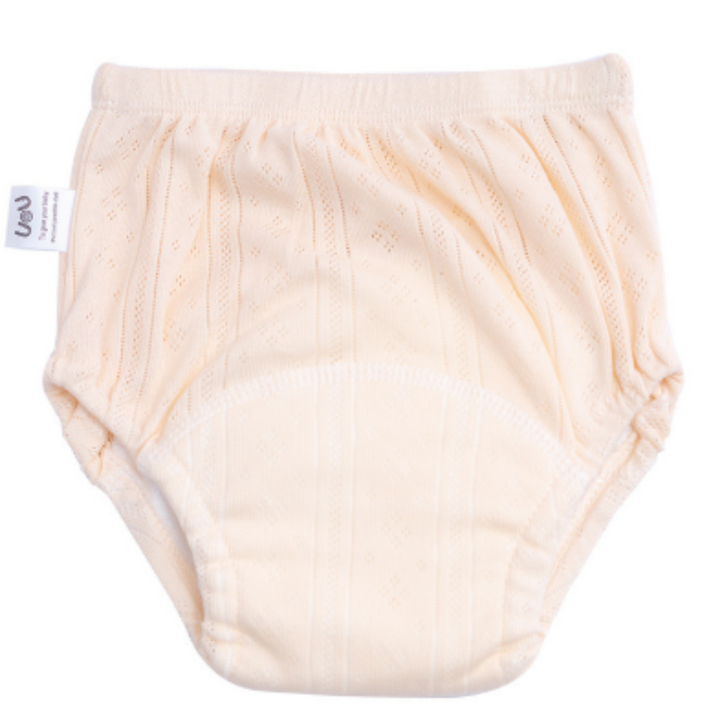 Peach-toned cotton training pants with elastic leg openings and a curved absorbent area.