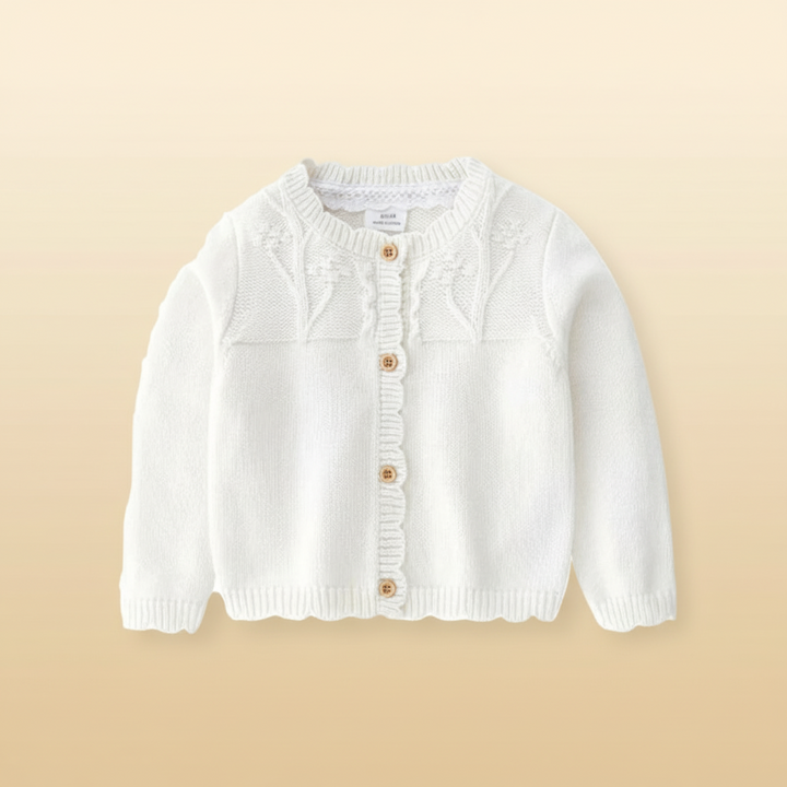 Pearl white baby cardigan with a textured yoke and scalloped button placket