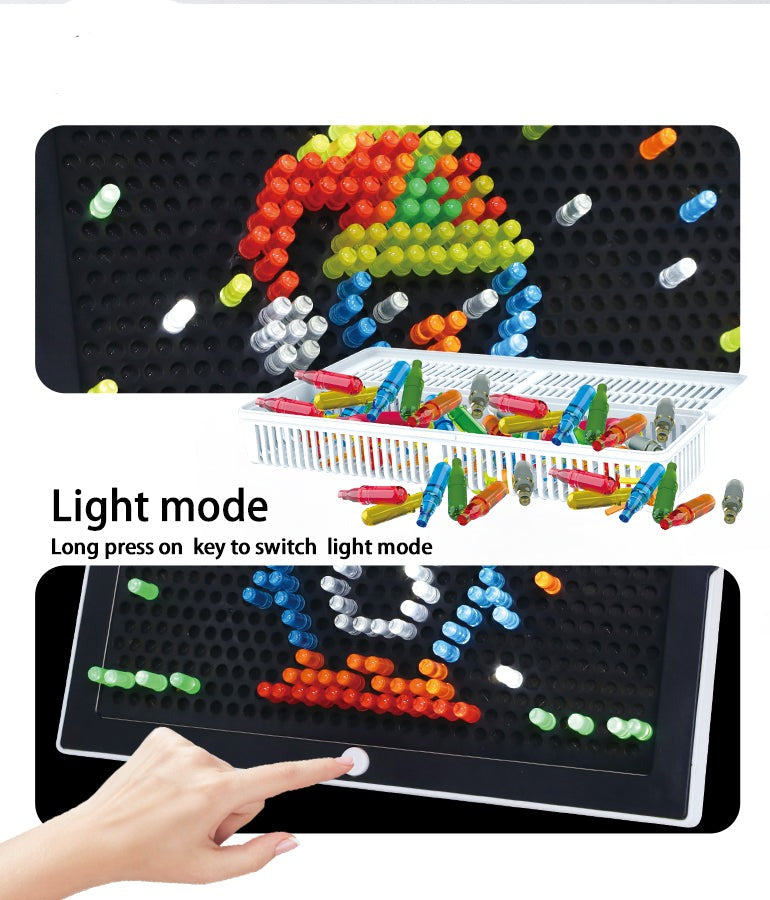 Peg board light-mode demonstration with a penguin design and a hand pressing the front button