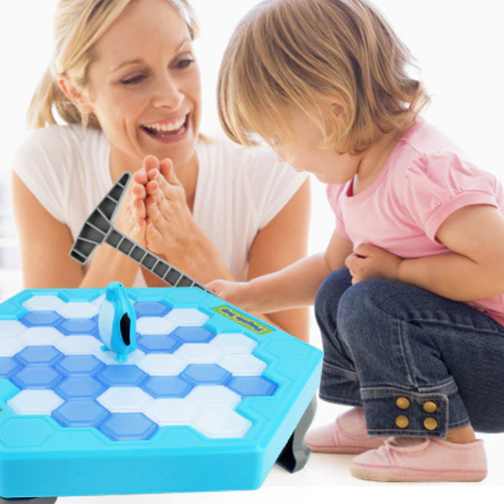 An adult and child playing the penguin ice block game together